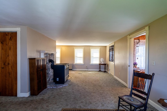 carpeted living area featuring baseboards
