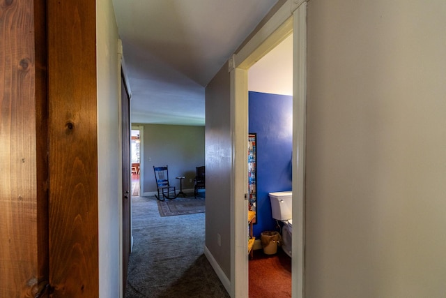 corridor featuring carpet flooring and baseboards