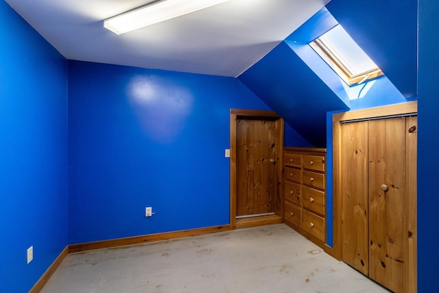bonus room with a skylight, lofted ceiling, and baseboards
