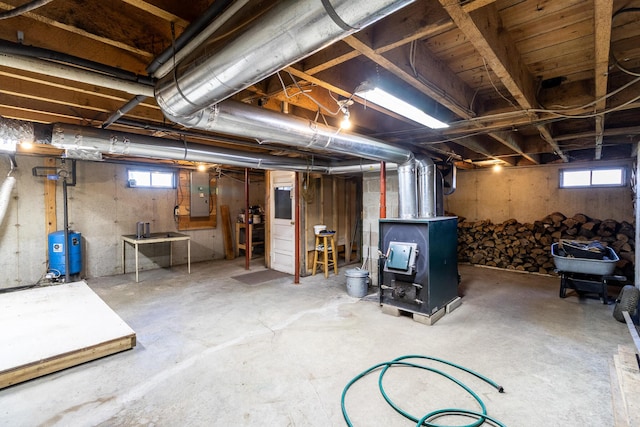 basement with electric panel, a water pressure tank, and heating unit