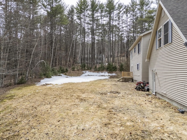 view of yard featuring a forest view