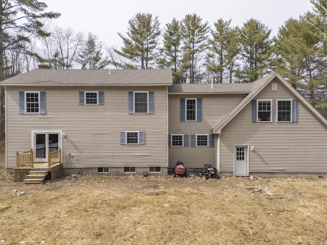 rear view of property with a shingled roof