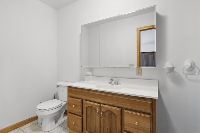 bathroom featuring baseboards, tile patterned flooring, vanity, and toilet