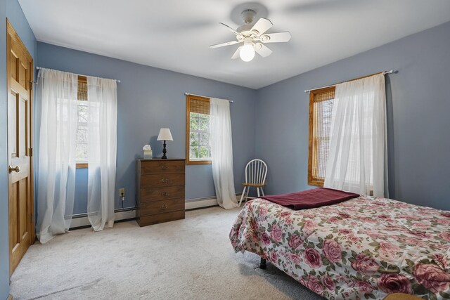 carpeted bedroom with baseboards and a ceiling fan