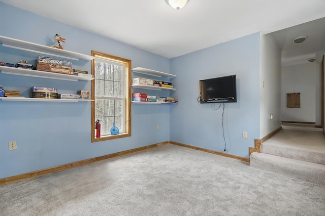 interior space featuring carpet floors, stairs, and baseboards