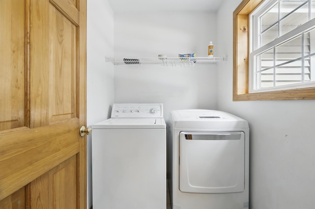 laundry area with washing machine and clothes dryer and laundry area