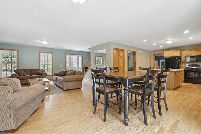 dining area with recessed lighting, light wood-style floors, and stairway