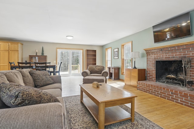 living room featuring light wood finished floors and a fireplace