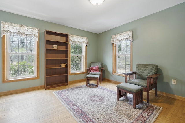sitting room featuring light wood-type flooring and baseboards