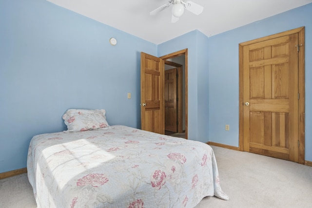 carpeted bedroom with a ceiling fan and baseboards