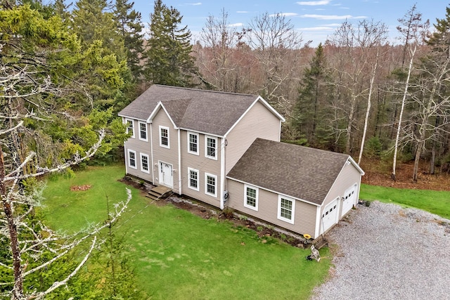 bird's eye view with a wooded view