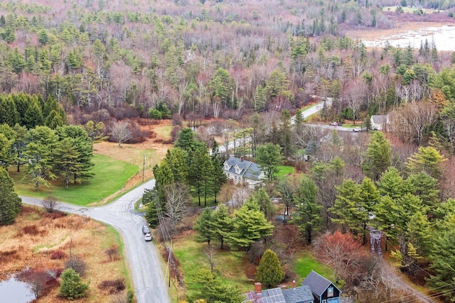 birds eye view of property featuring a forest view
