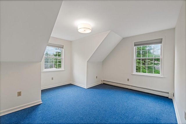 bonus room with a wealth of natural light, vaulted ceiling, a baseboard heating unit, and carpet floors