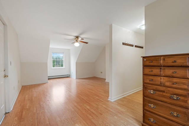 bonus room featuring baseboards, ceiling fan, a baseboard heating unit, light wood-style floors, and lofted ceiling