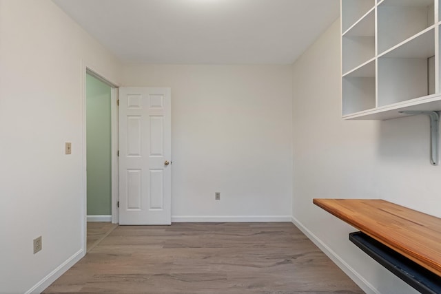 interior space featuring wood finished floors and baseboards