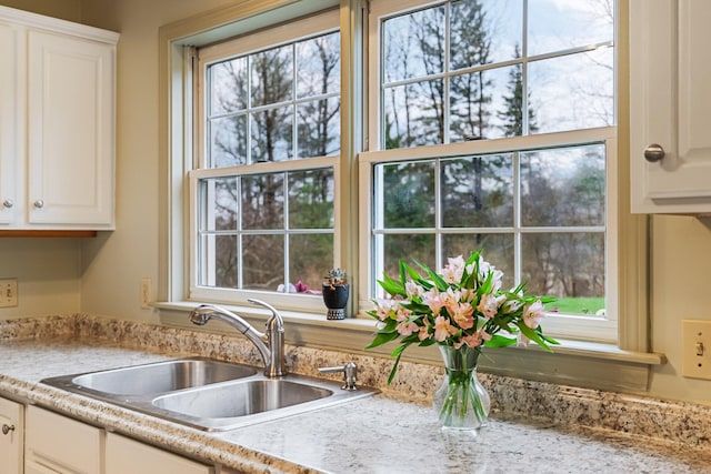 kitchen with light countertops, a sink, and plenty of natural light