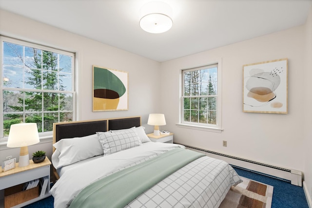 bedroom with carpet flooring, baseboard heating, and multiple windows