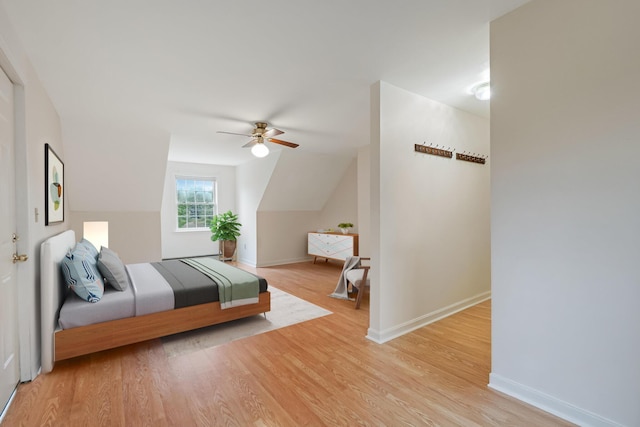 bedroom featuring baseboards, lofted ceiling, a ceiling fan, and wood finished floors