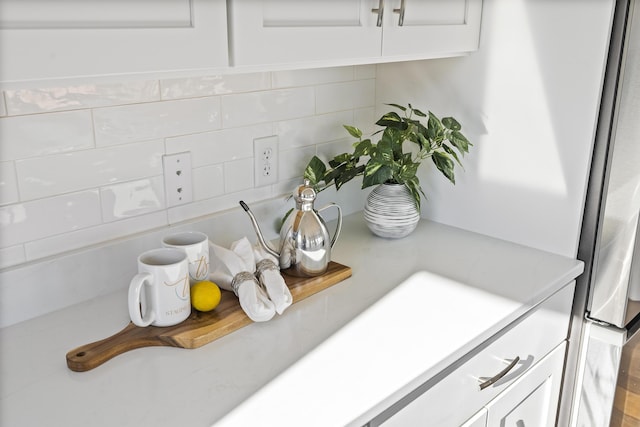 148 Newbury St Unit 2, Portland, ME 04101 - interior details with white cabinets, tasteful backsplash, and light countertops