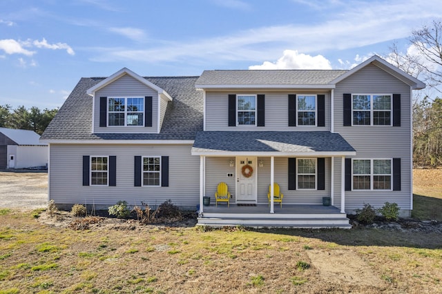 6 Jackson Ln, Kennebunk, ME 04043 - traditional-style home with a porch, a front lawn, and a shingled roof
