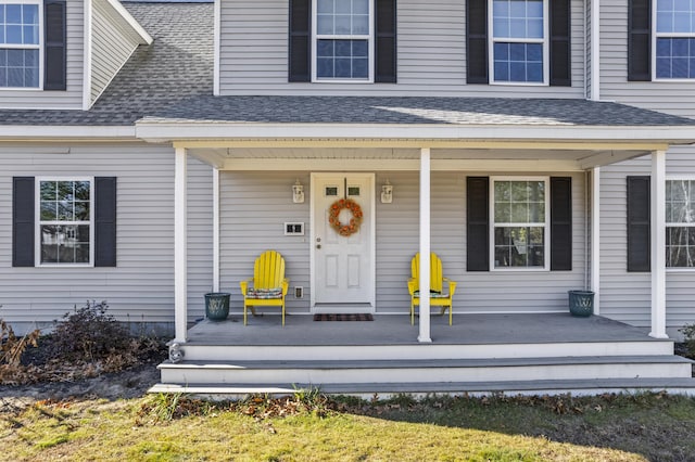6 Jackson Ln, Kennebunk, ME 04043 - view of exterior entry with a shingled roof and covered porch