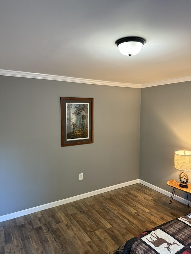 interior space with baseboards, ornamental molding, and dark wood finished floors