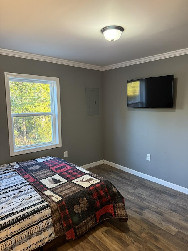 bedroom featuring dark wood-type flooring, electric panel, baseboards, and ornamental molding