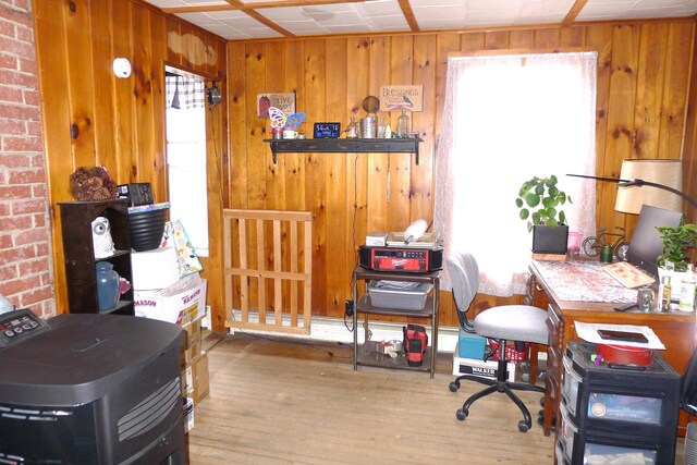 home office with wood finished floors and wood walls