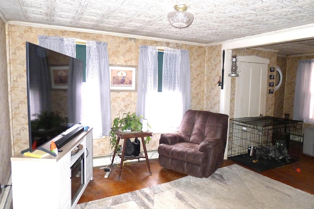 living area with crown molding, an ornate ceiling, wood finished floors, and wallpapered walls