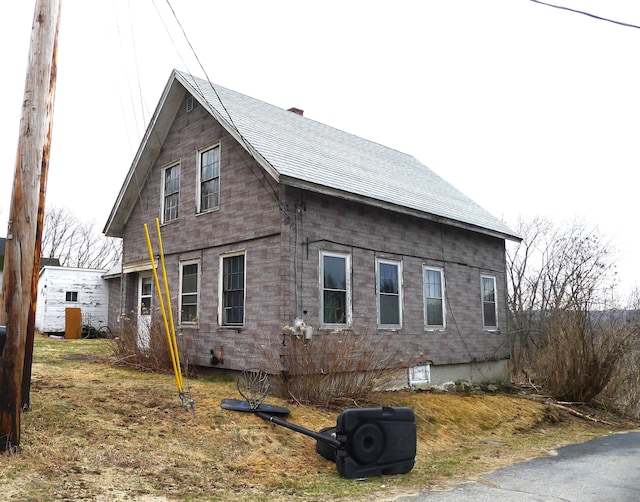 view of home's exterior featuring a shingled roof
