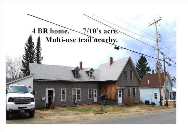 view of front of house featuring a chimney