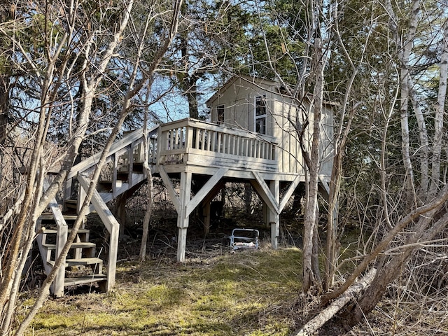 view of side of home with stairway and a wooden deck