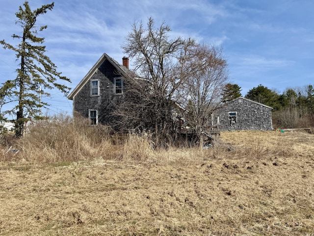 view of side of home with a chimney