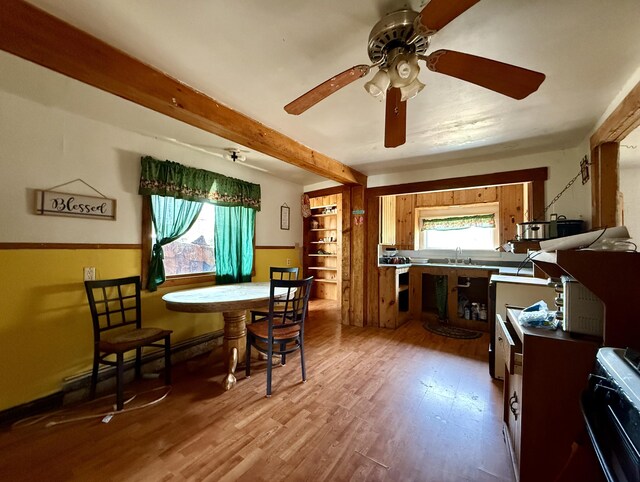 interior space featuring beamed ceiling, wood finished floors, and a ceiling fan