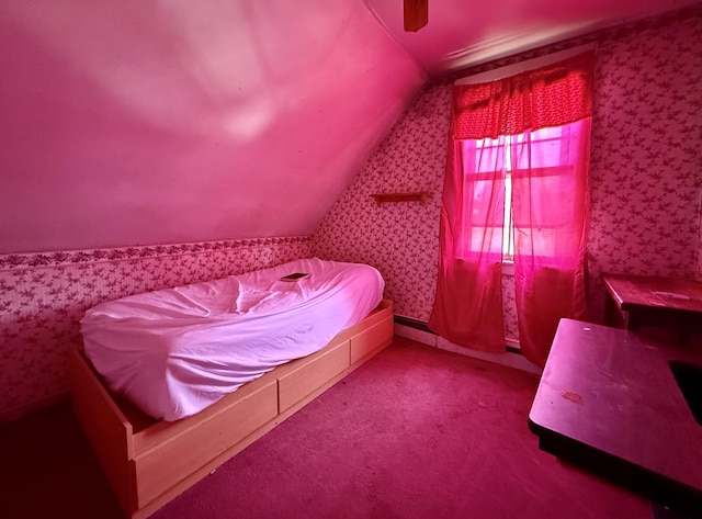 bedroom with wallpapered walls, lofted ceiling, and a ceiling fan