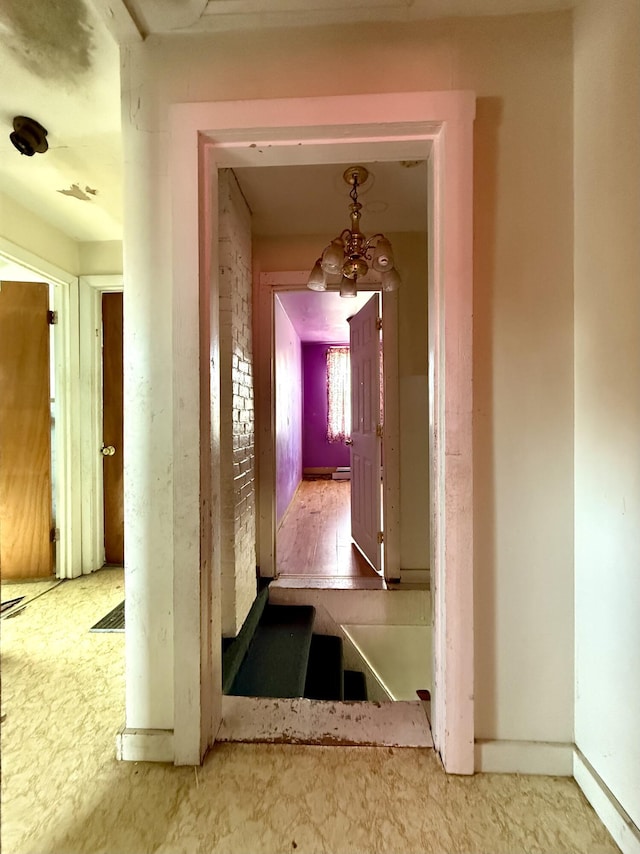 corridor featuring a chandelier