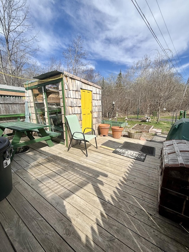 deck with fence and an outbuilding