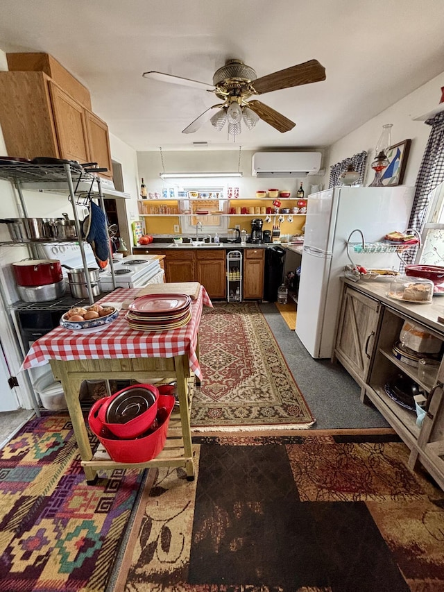 kitchen with brown cabinetry, freestanding refrigerator, ceiling fan, and a wall unit AC