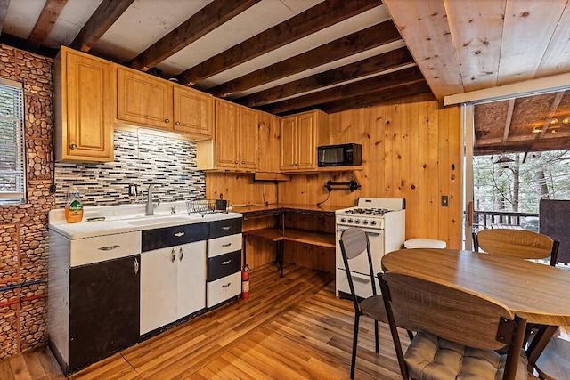 37 Torsey Shores Rd, Readfield, ME 04355 - kitchen with black microwave, white gas stove, a sink, light wood-type flooring, and beamed ceiling