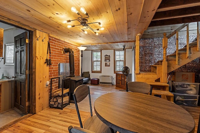 37 Torsey Shores Rd, Readfield, ME 04355 - dining room with light wood finished floors, a wood stove, stairway, and wooden ceiling