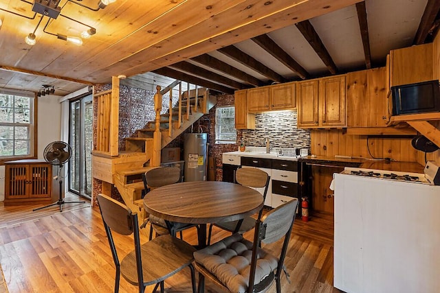 37 Torsey Shores Rd, Readfield, ME 04355 - dining room featuring electric water heater, light wood-type flooring, healthy amount of natural light, radiator heating unit, and beamed ceiling