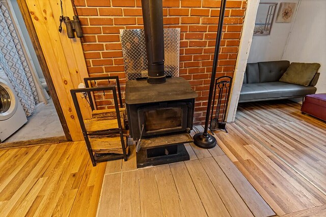37 Torsey Shores Rd, Readfield, ME 04355 - detailed view of a wood stove, wood finished floors, and washer / clothes dryer