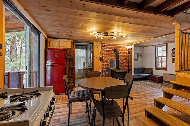 37 Torsey Shores Rd, Readfield, ME 04355 - dining area with a wood stove, wooden ceiling, and light wood-style floors