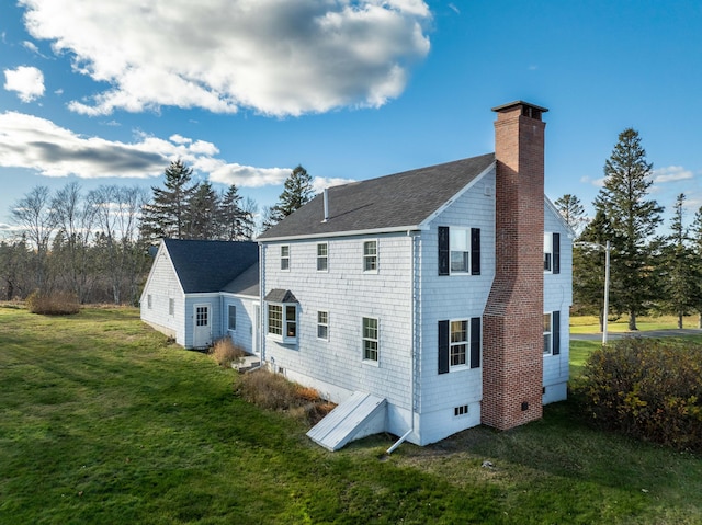 812 County Rd, Lubec, ME 04652 - rear view of property featuring a chimney, a lawn, a shingled roof, and crawl space