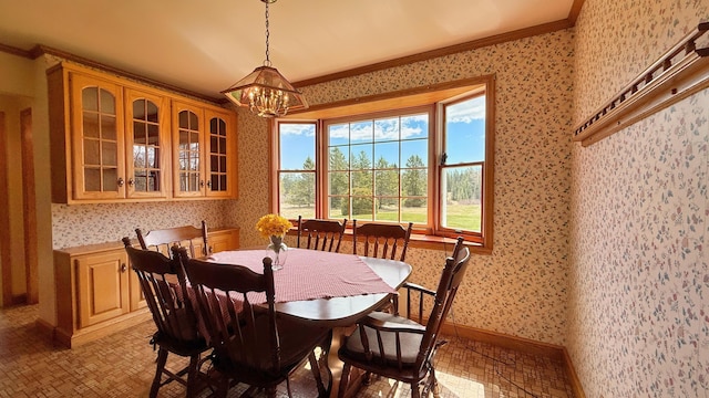 812 County Rd, Lubec, ME 04652 - dining room with wallpapered walls, a chandelier, crown molding, and baseboards