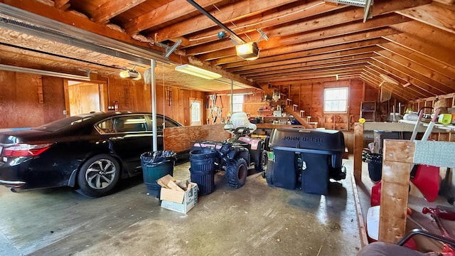 812 County Rd, Lubec, ME 04652 - garage featuring a garage door opener and wood walls