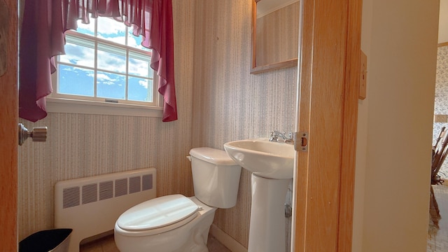 812 County Rd, Lubec, ME 04652 - half bathroom featuring radiator, wallpapered walls, and toilet