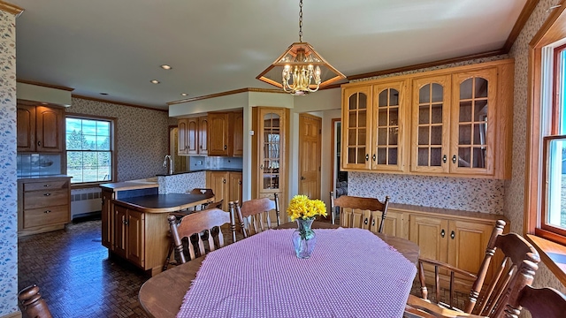 812 County Rd, Lubec, ME 04652 - dining area featuring wallpapered walls, ornamental molding, a chandelier, and radiator