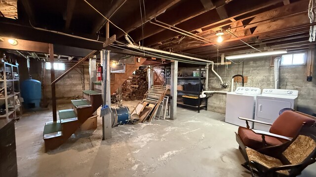 812 County Rd, Lubec, ME 04652 - basement featuring washer and dryer, a water pressure tank, and stairs