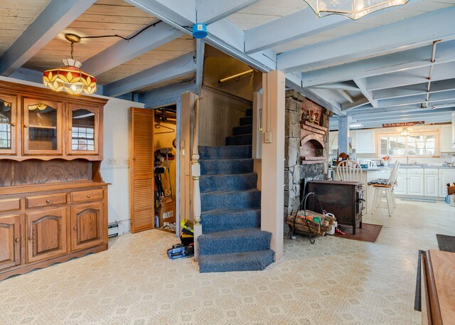 84 Hillside Rd, Westbrook, ME 04092 - below grade area with light carpet, baseboard heating, and stairway